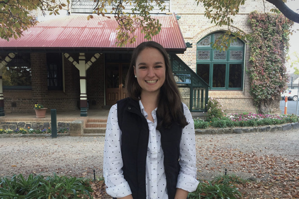 Emma standing in front of an old building