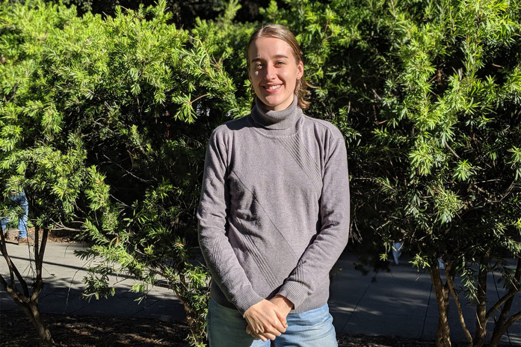 Kellie standing in front of trees