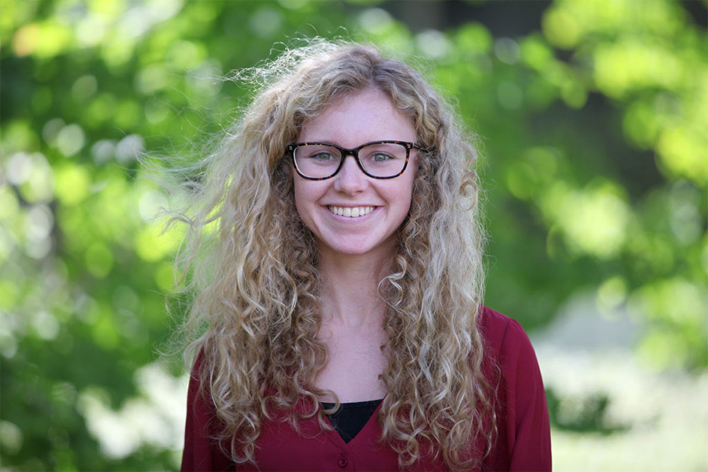 Montana standing in front of trees