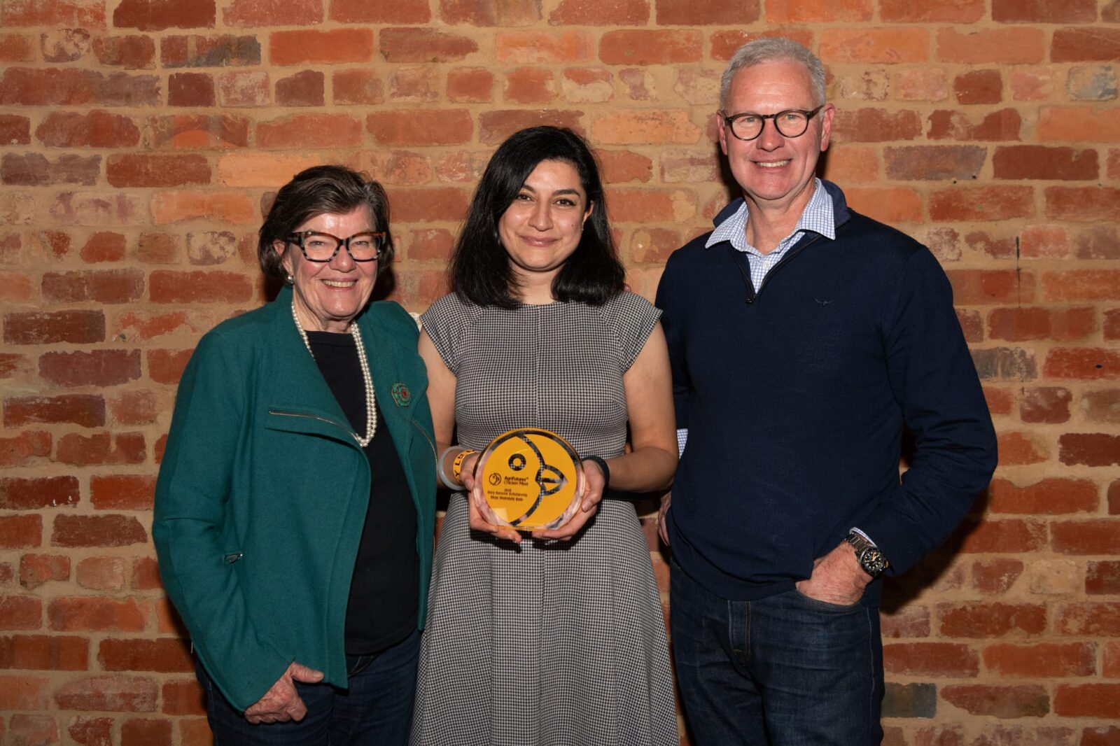 Image of Cathy McGowan AO, Shay Sadr (2025 Gary Sansom Scholarship recipient) and John Harvey